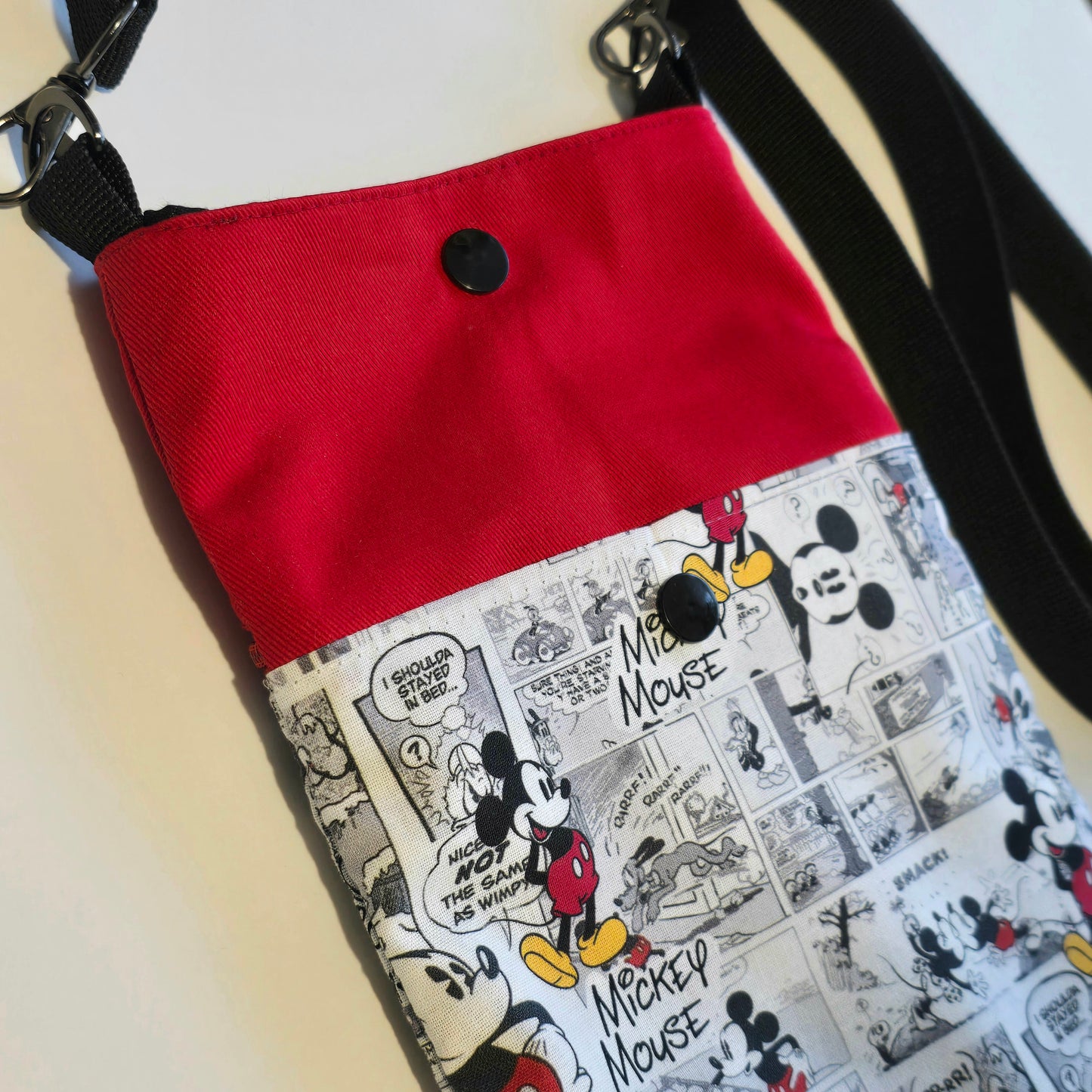 rear view of a handmade phone bag featuring comic print fabric and pocket with closure