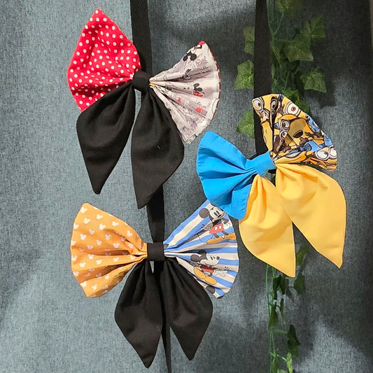 Handmade patchwork hair bows featuring coordinated character-inspired fabrics in three colourways