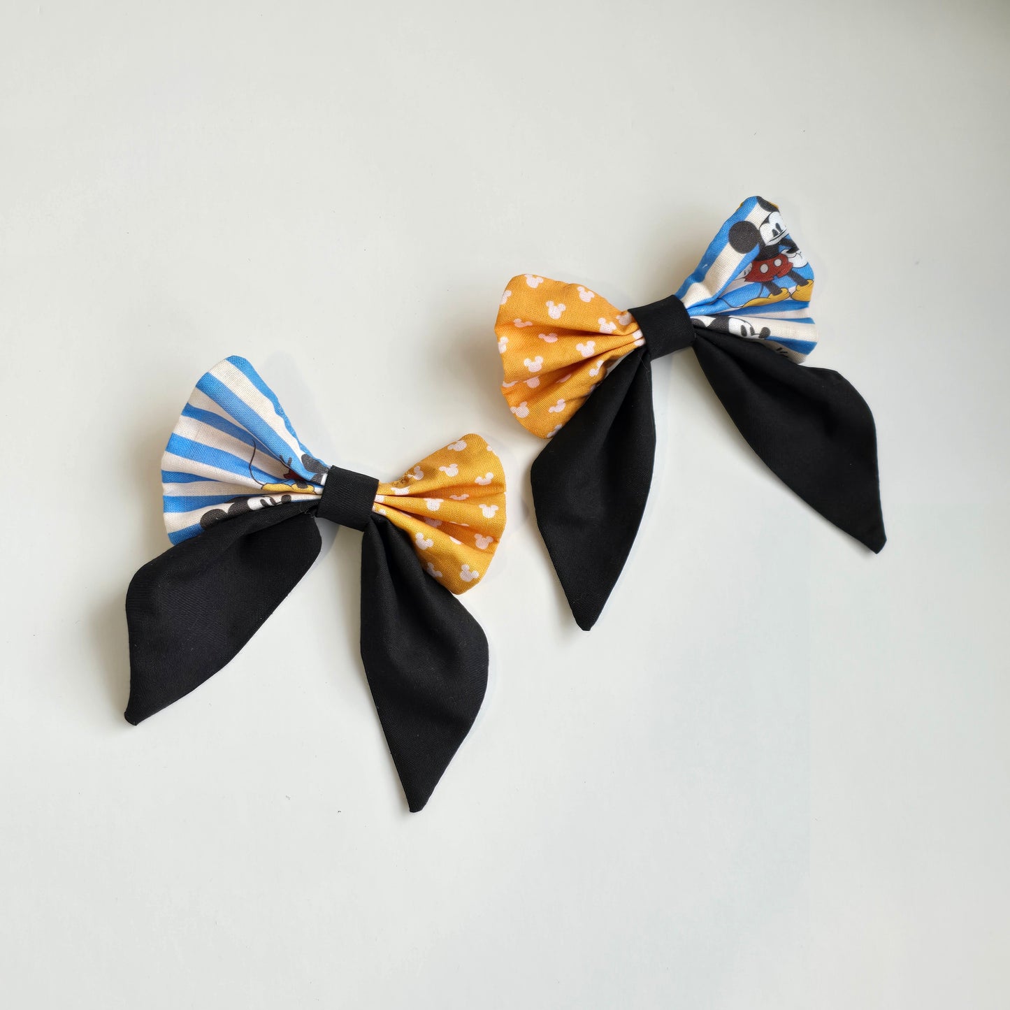 Handmade blue and yellow patchwork hair bow with character-inspired fabric accent