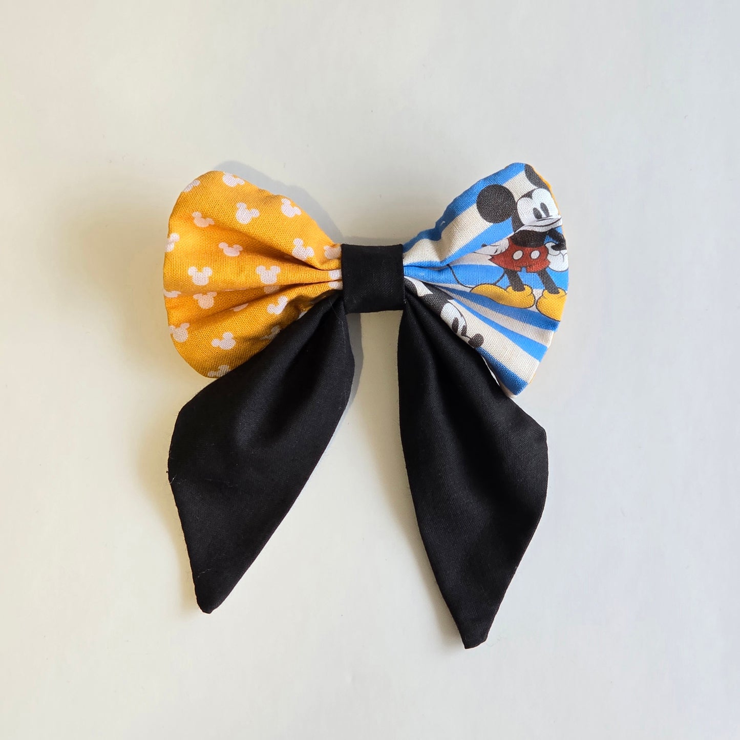 Handmade yellow and blue striped patchwork boutique hair bow with coordinating printed fabric