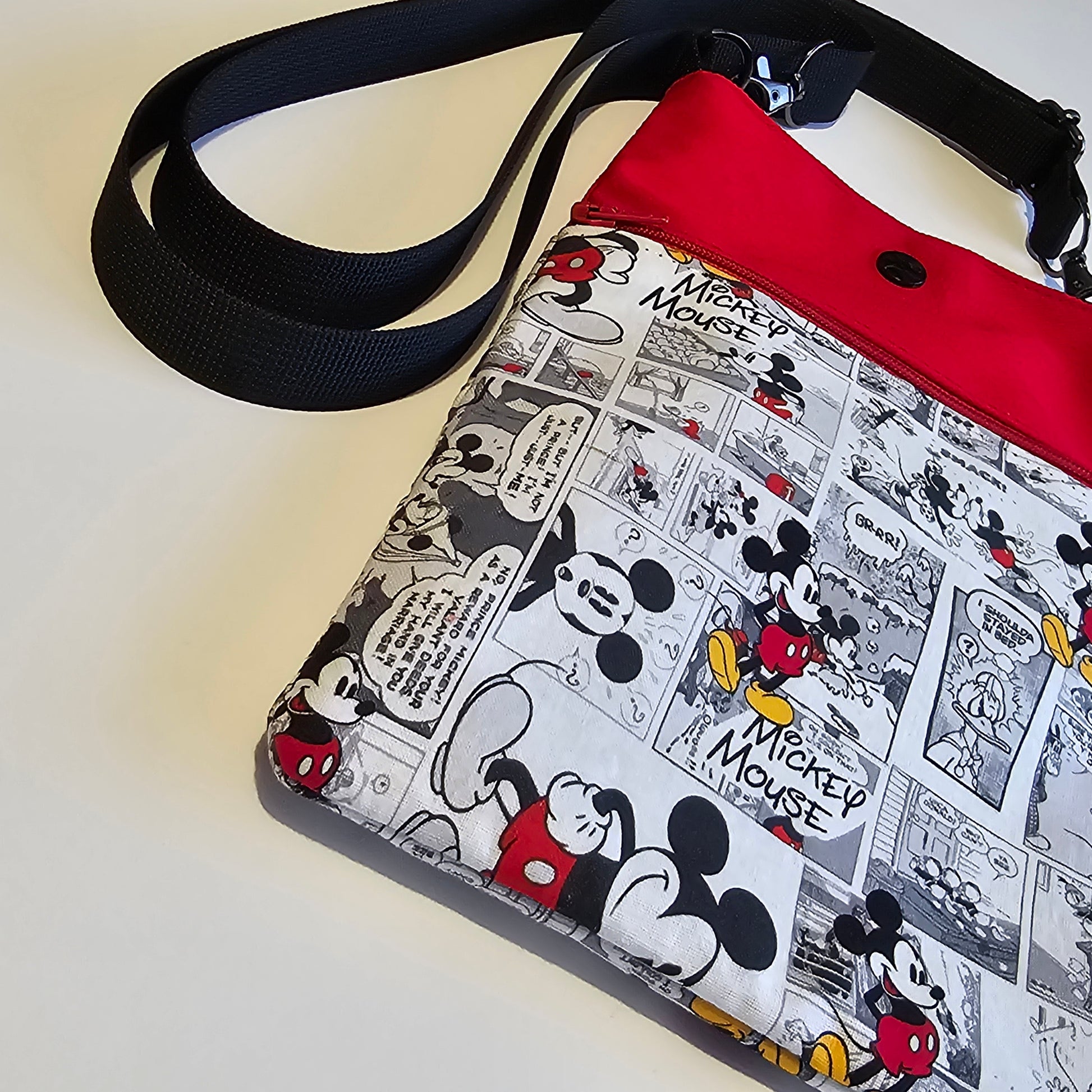 Angled front view of colour block crossbody phone bag with adjustable black strap and secure zip closure