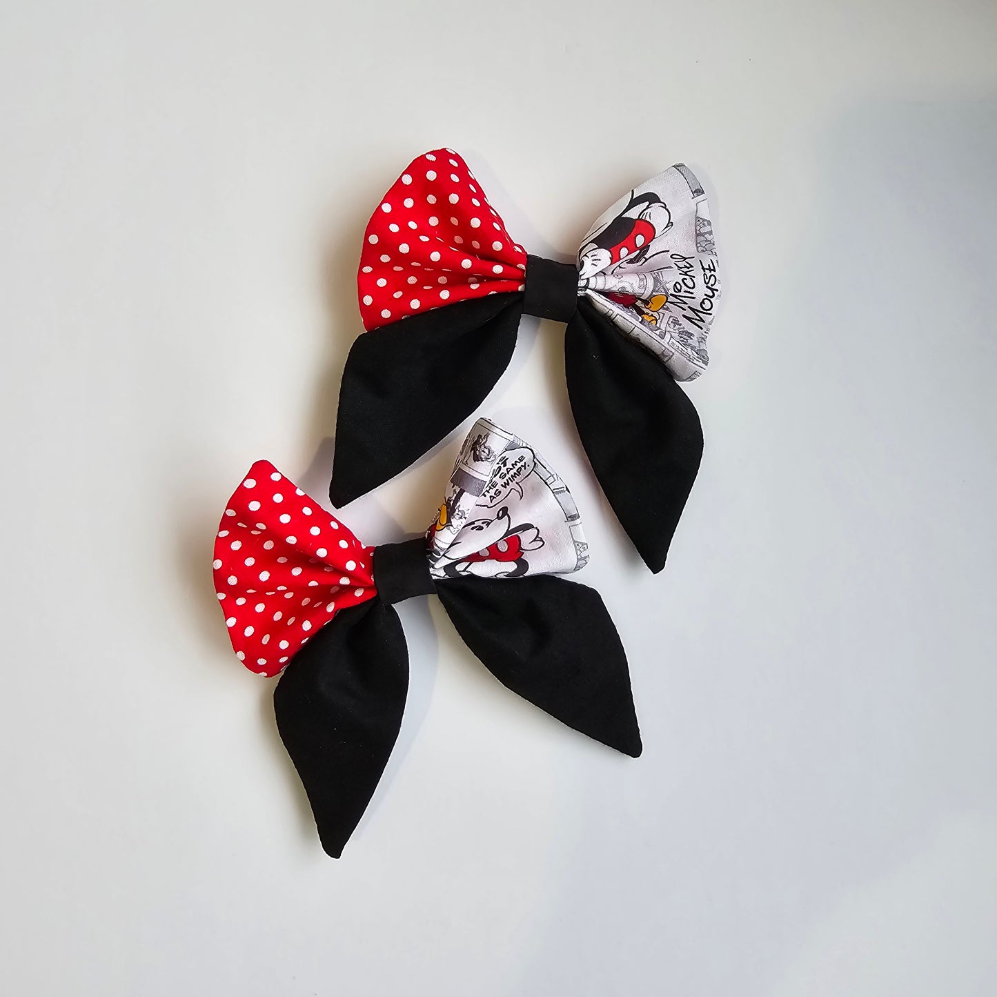 Pair of handmade patchwork hair bows with red polka dot and printed fabric panels